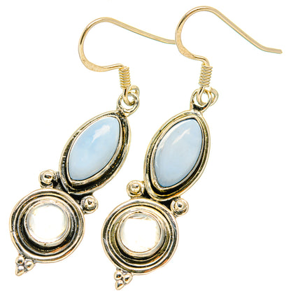 Rainbow moonstone earrings with oval blue opal and round white center, silver-tone hooks