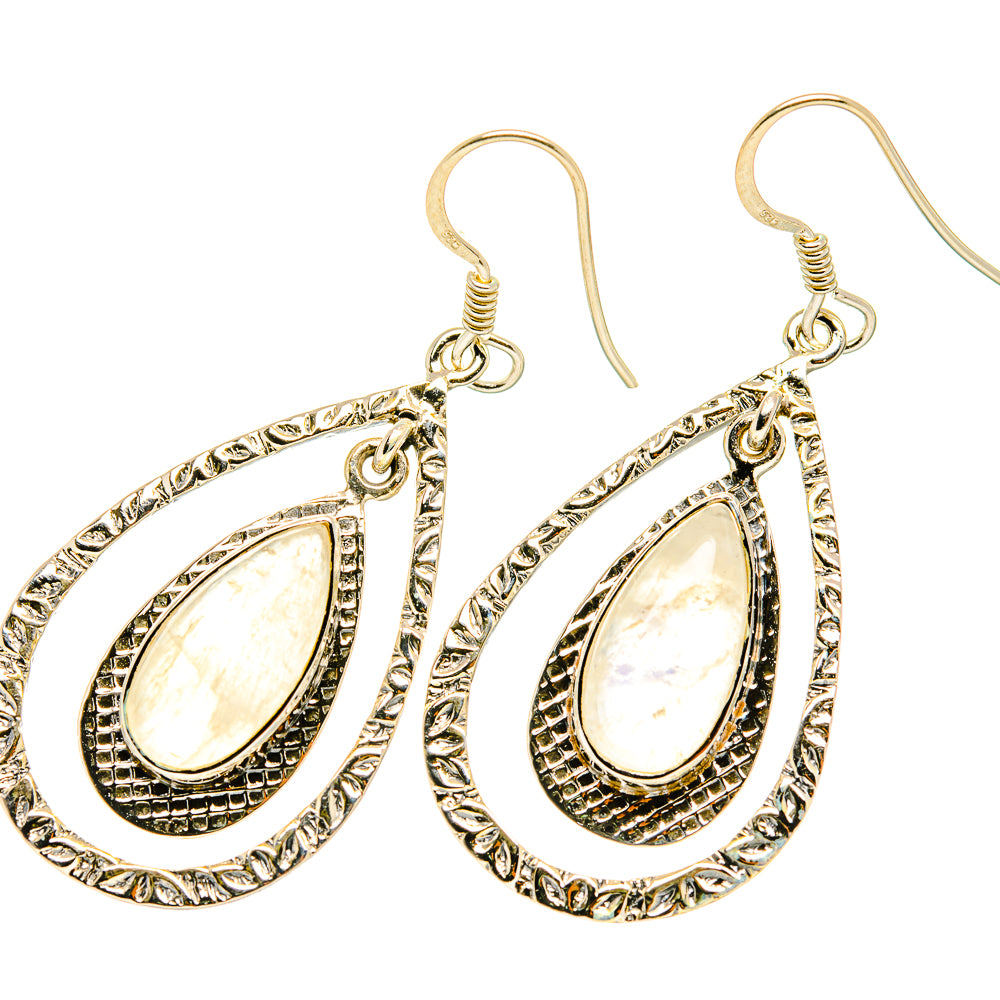 Teardrop earrings with oval moonstone-like center, textured silver-toned metal, hook backs