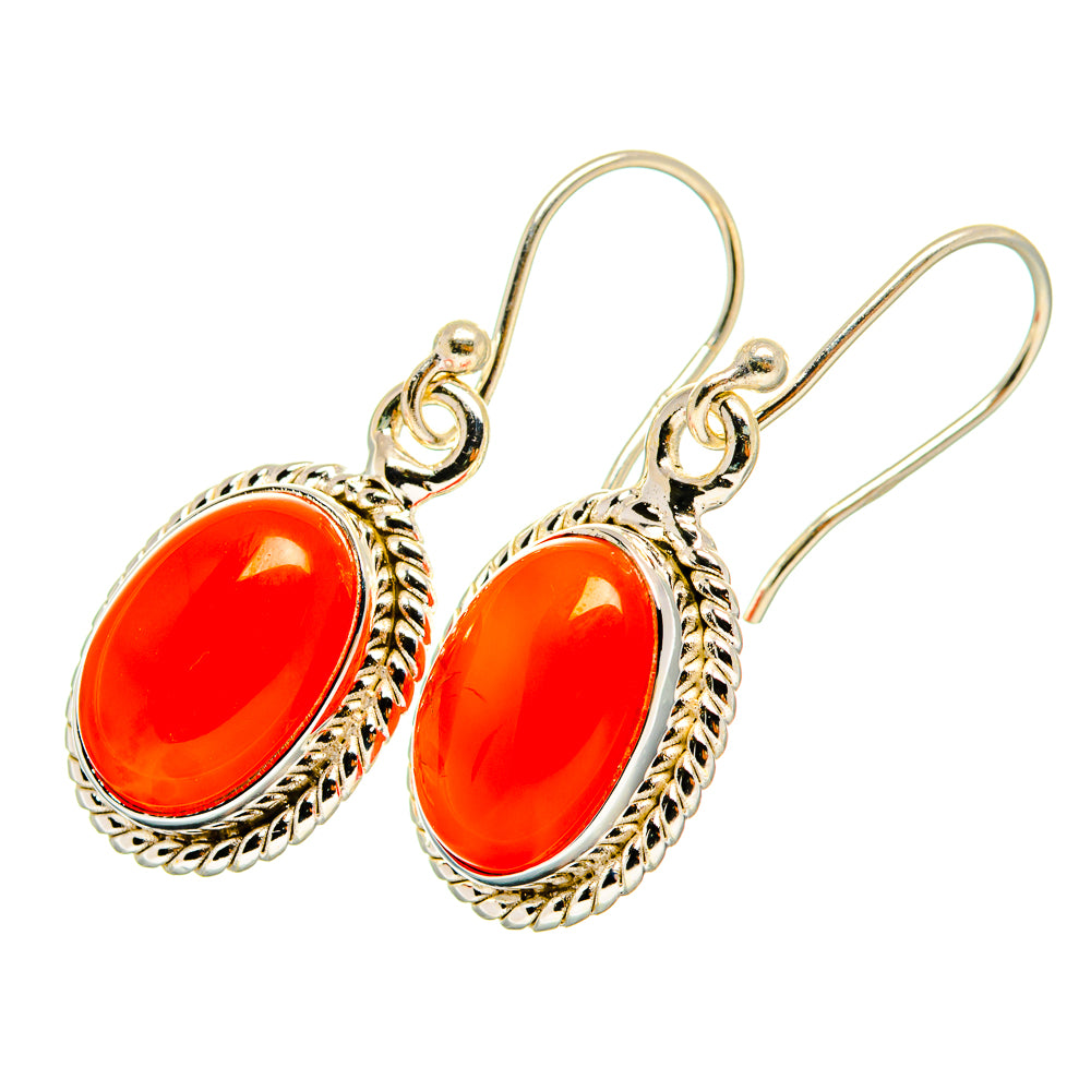 Oval orange carnelian drop earrings with textured silver frames and curved hooks