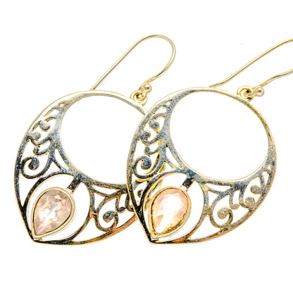 Rose quartz earrings with openwork silver hoop settings and round pink stones