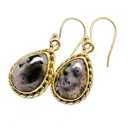 Oval gabbro stone drop earrings with gold-tone bezel, black speckled stone, silver hook