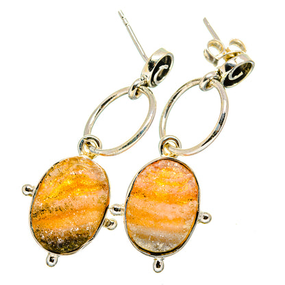 Oval druzy earrings with orange-peach stone drops and silver hoop links, ear wires