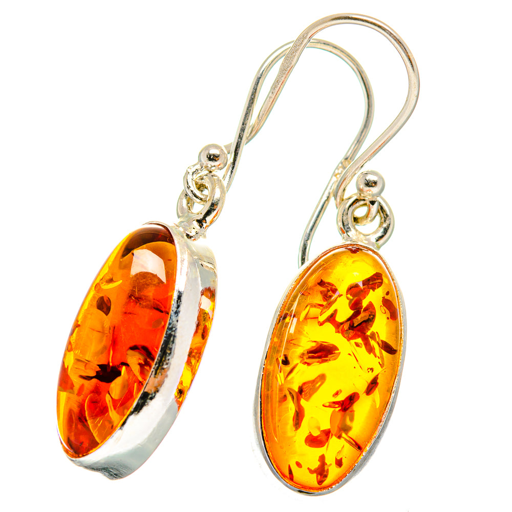 Amber oval dangle earrings in sterling silver with ornate hoop hooks, orange amber drops