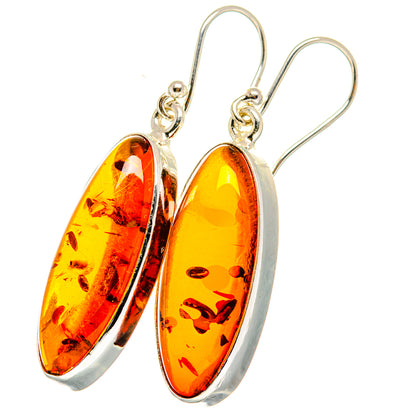 Sterling silver drop earrings with amber oval stones and visible hook closures