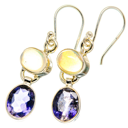 Gold-tone drop earrings with round light opal and faceted deep purple teardrop stones