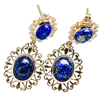 Lapis lazuli drop earrings with oval blue stones and ornate silver filigree