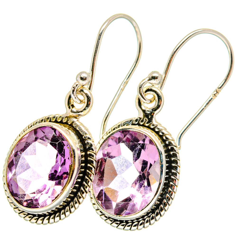 Amethyst teardrop earrings with faceted purple gemstone in ornate silver halo