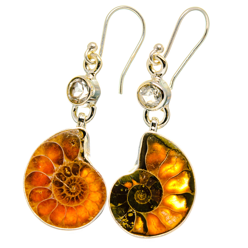Silver drop earrings with faceted clear stones and orange-brown ammonite fossil pendants
