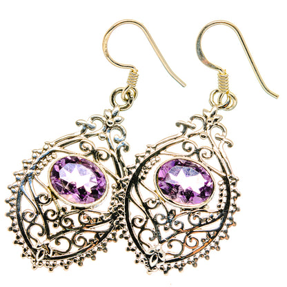 Dangling sterling silver filigree earrings with faceted amethyst purple circular stones