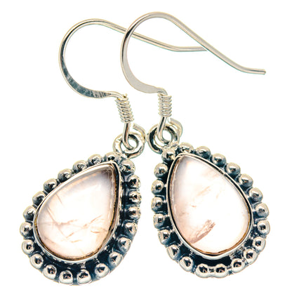 Rose quartz teardrop earrings with silver-tone scalloped bezel and visible ear wires
