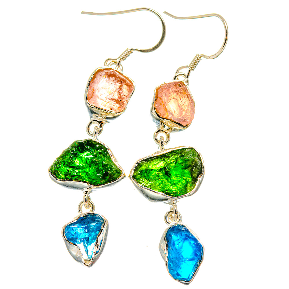 Dangling sterling silver earrings with rough orange, green, and blue stones