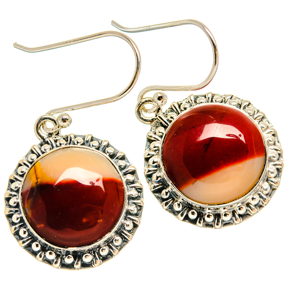 Pair of round amber-red cabochon earrings with ornate silver bezel and curved hooks