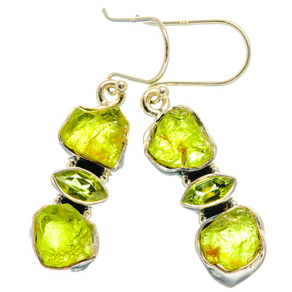 Silver hook earrings featuring three bright green rough peridot stones with faceted edges