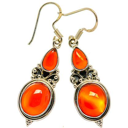 Carnelian earrings with orange teardrop and oval stones in sterling silver settings