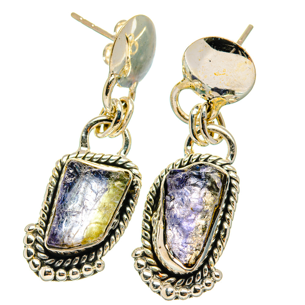 Sterling silver dangling earrings with rough violet-blue stones in ornate frames, chain links