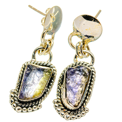 Sterling silver dangling earrings with rough violet-blue stones in ornate frames, chain links