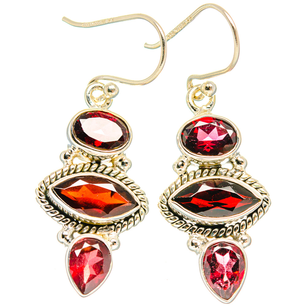 Sterling silver drop earrings with red oval, diamond, and teardrop stones on filigree