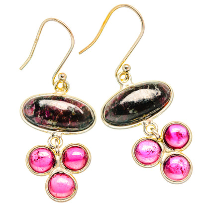 Sterling silver oval drop earrings with pink-speckled stones and four pink round gems