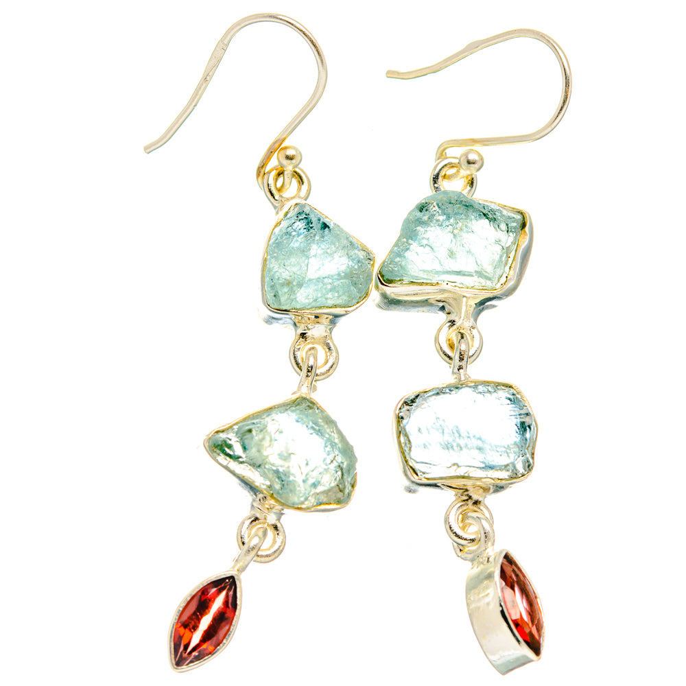 Gold-tone dangling earrings with rough aqua-blue stones and red garnet teardrops