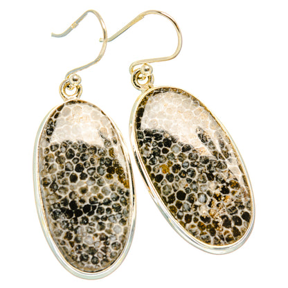 Sterling silver oval drop earrings with speckled stone-like inlay and curved frames