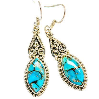 Turquoise teardrop dangling earrings with ornate silver-tone filigree and hook backs