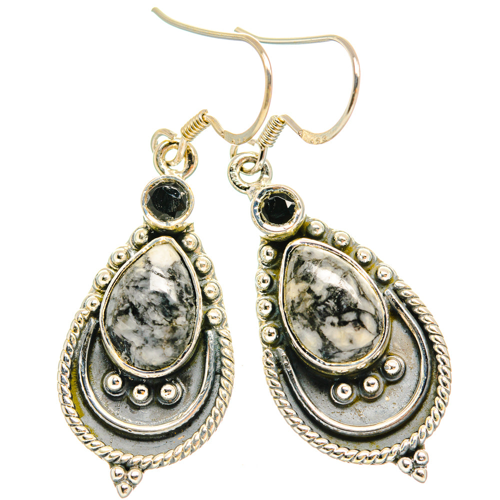 Silver teardrop dangle earrings with black tops and white marbled oval drops.