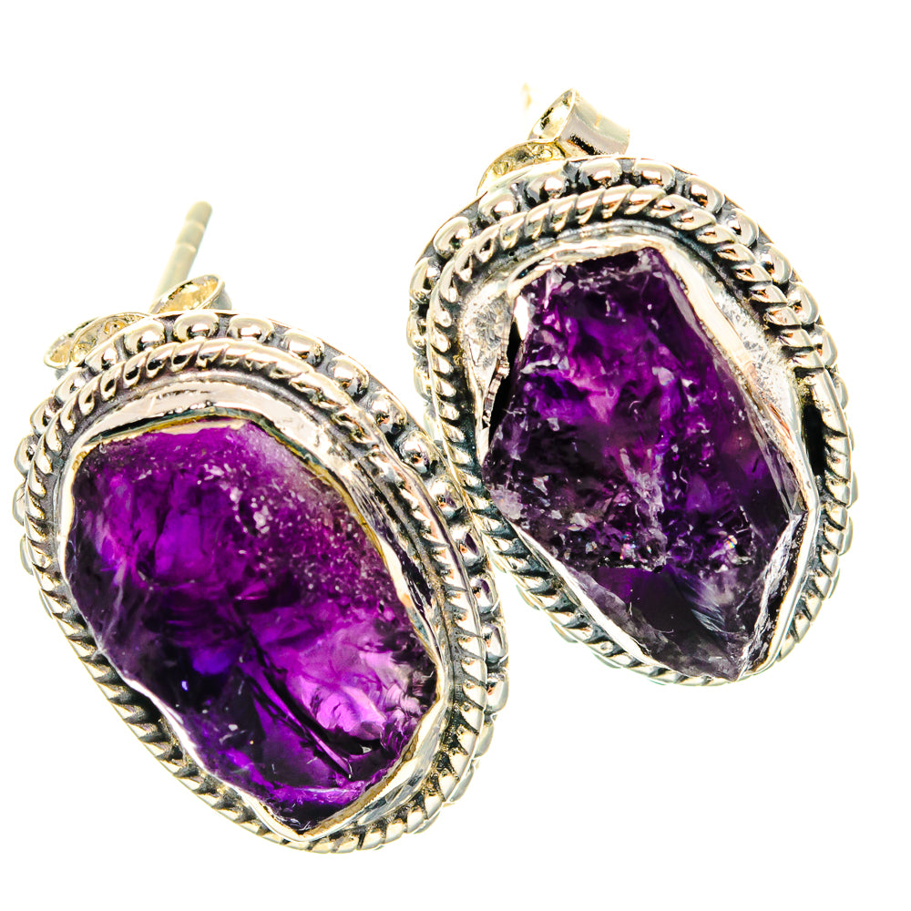 Sterling silver amethyst stud earrings with faceted purple teardrop stone