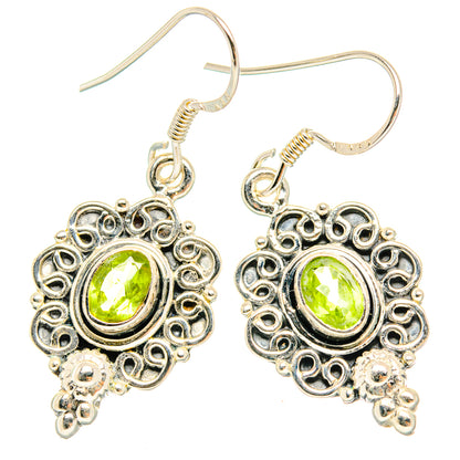 Sterling silver peridot chandelier earrings with oval green center stones and filigree drops