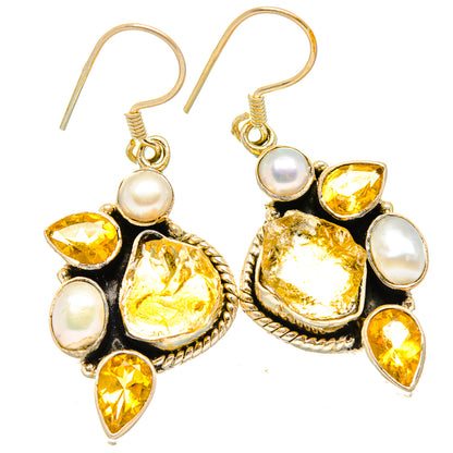 Drop earrings with citrine yellow stones, cultured pearls, and gold-tone hooks