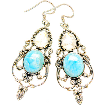 Sterling silver drop earrings with oval moonstone-like and light-blue gemstones, leaf accents