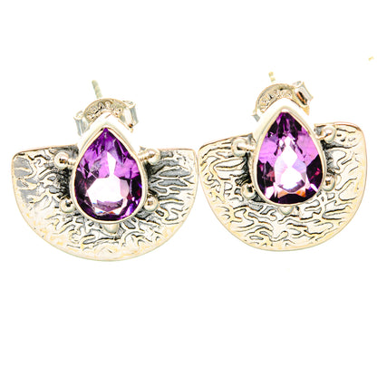 Amethyst drop earrings with faceted pear-shaped purple stones and ornate silver finish
