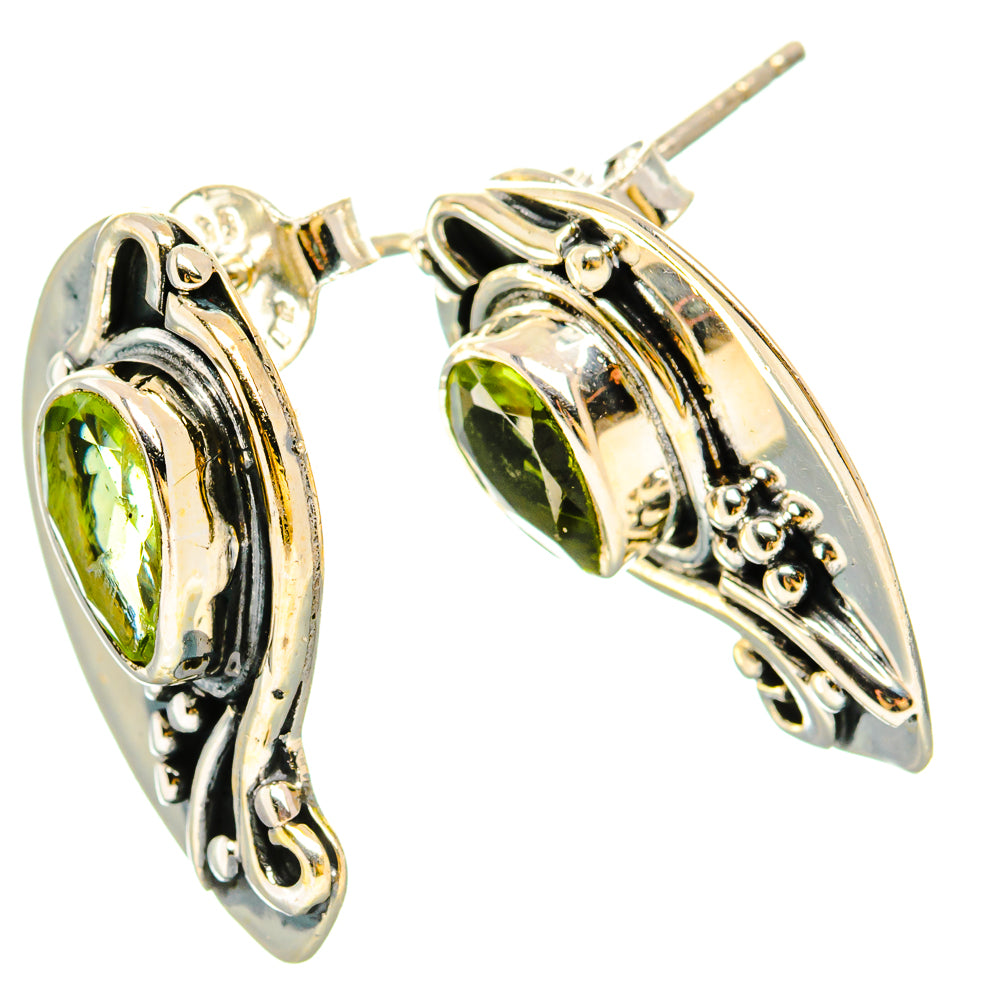 925 sterling silver peridot stud earrings with green teardrop stones and decorative side filigree