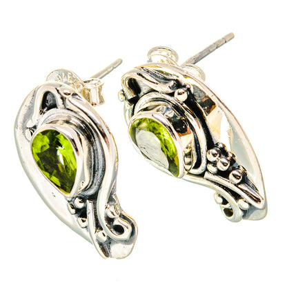 925 sterling silver peridot earrings with teardrop bezels and decorative scrollwork