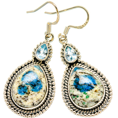 Sterling silver drop earrings with blue teardrop stones and textured oval frames