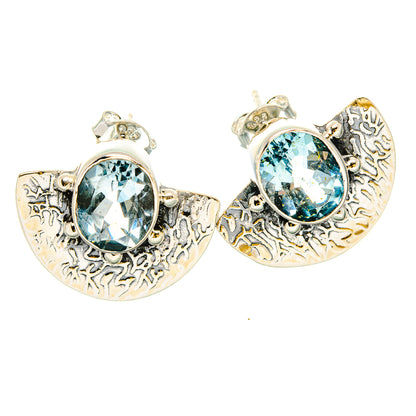 Pair of round blue topaz earrings in textured silver crescent frames