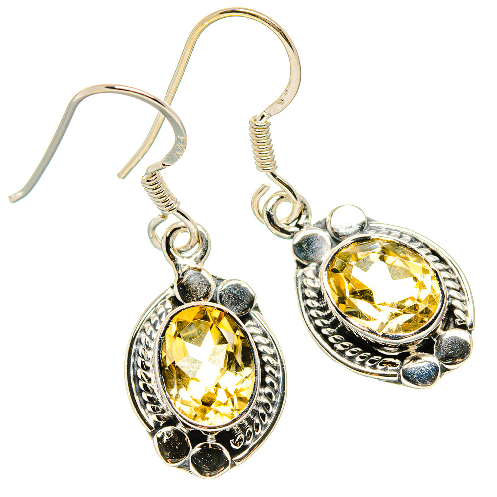 Sterling silver citrine drop earrings with faceted oval stones and ornate halo settings