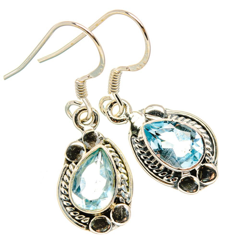 Sterling silver blue topaz drop earrings with ornate oval settings and fishhook backs