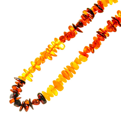 Baltic amber bead necklace with dark resin accents and multicolor orange stones
