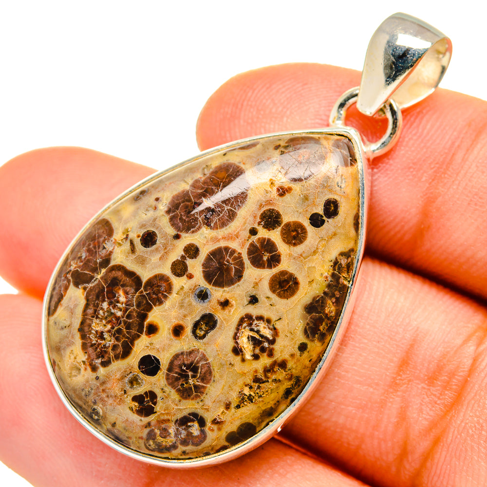 Poppy jasper teardrop pendant, 925 sterling silver bail; held in fingertips