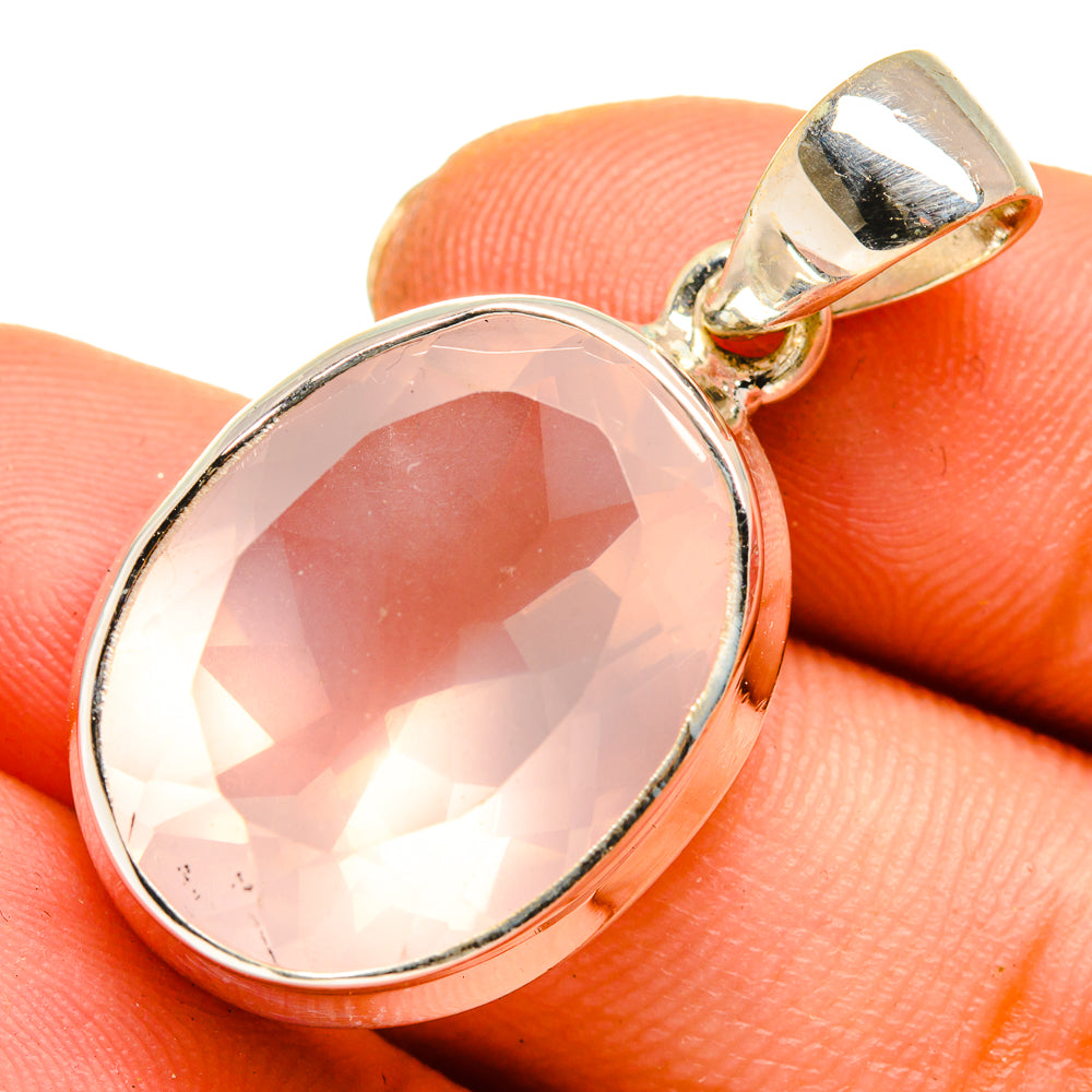 Rose quartz oval pendant with silver bezel and gold-tone bail, polished sterling finish