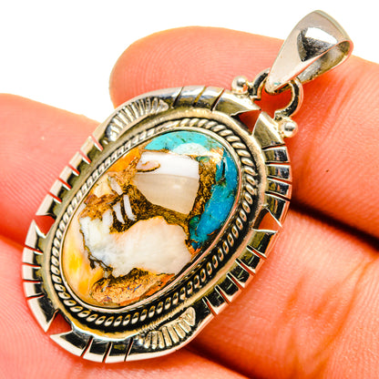 Oval turquoise composite pendant with gold-tone bezel, close-up detail on stone surface