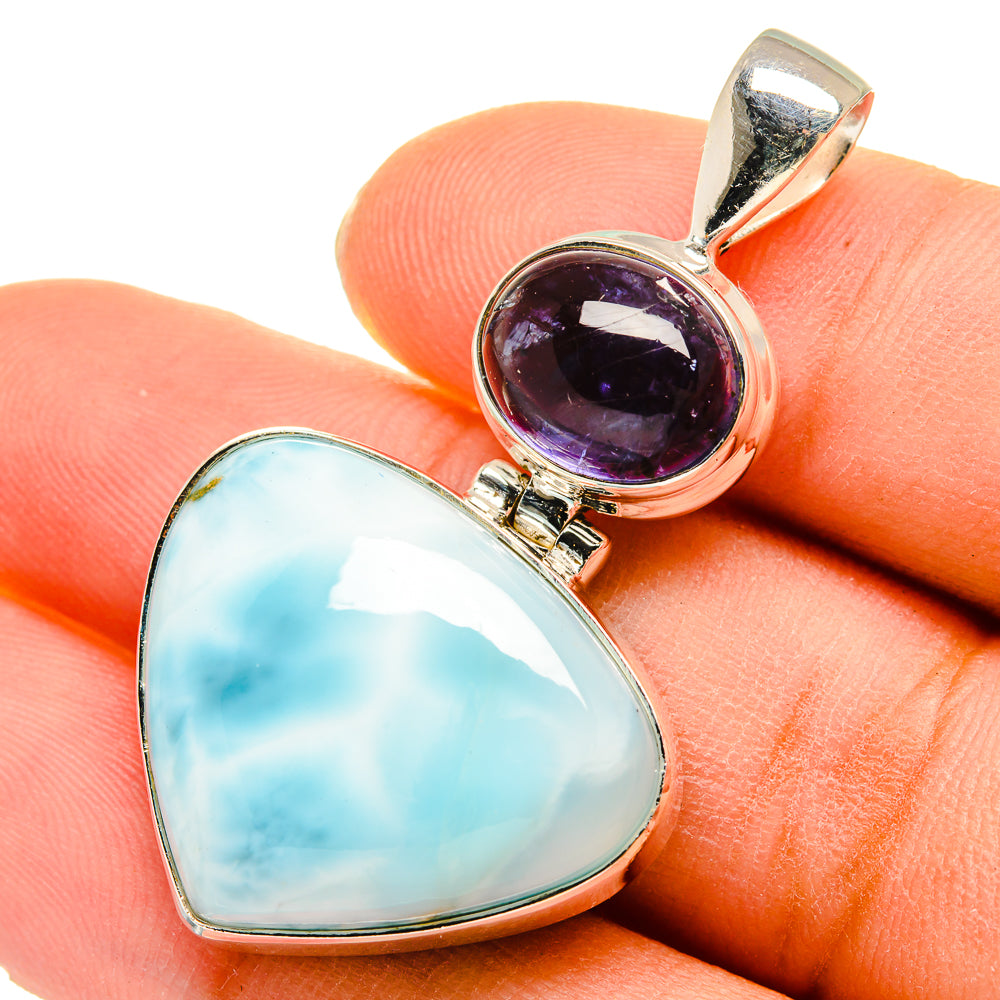 Sterling silver pendant with oval light blue stone and round purple stone bezel setting