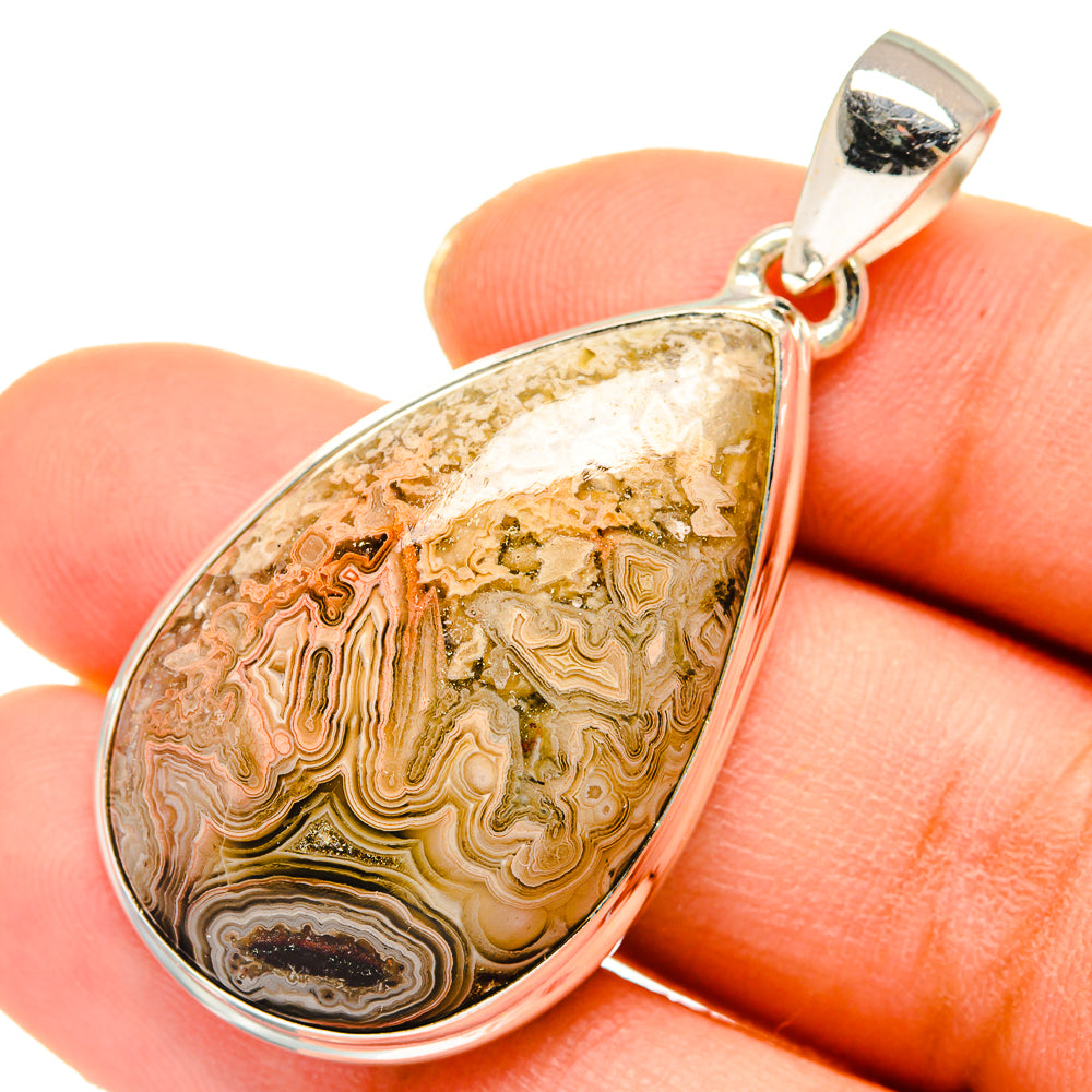 Teardrop agate pendant with gold-brown and white banded stone in silver bezel