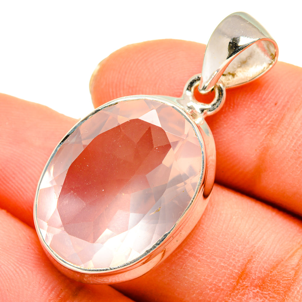 Rose quartz oval pendant close-up with faceted pink stone and silver bail