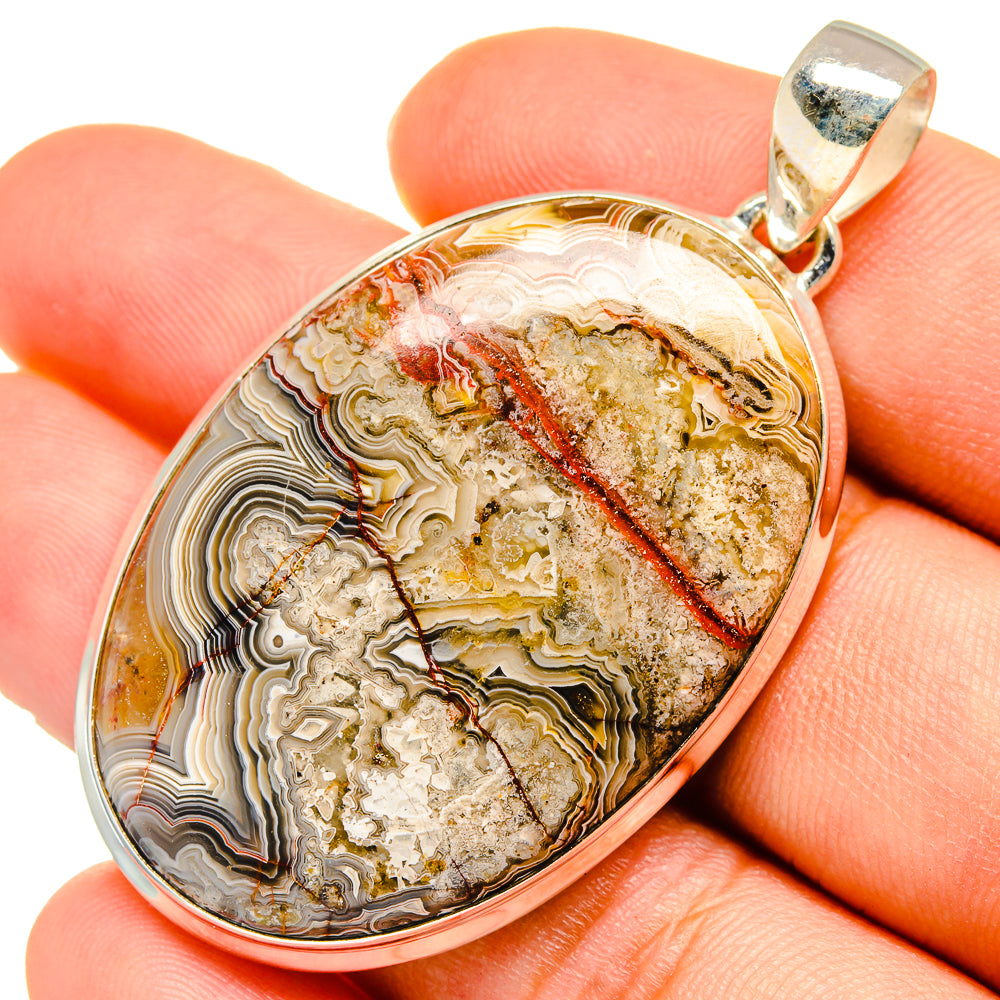 Sterling silver oval agate pendant with multicolor bands and red streak; hinged bail