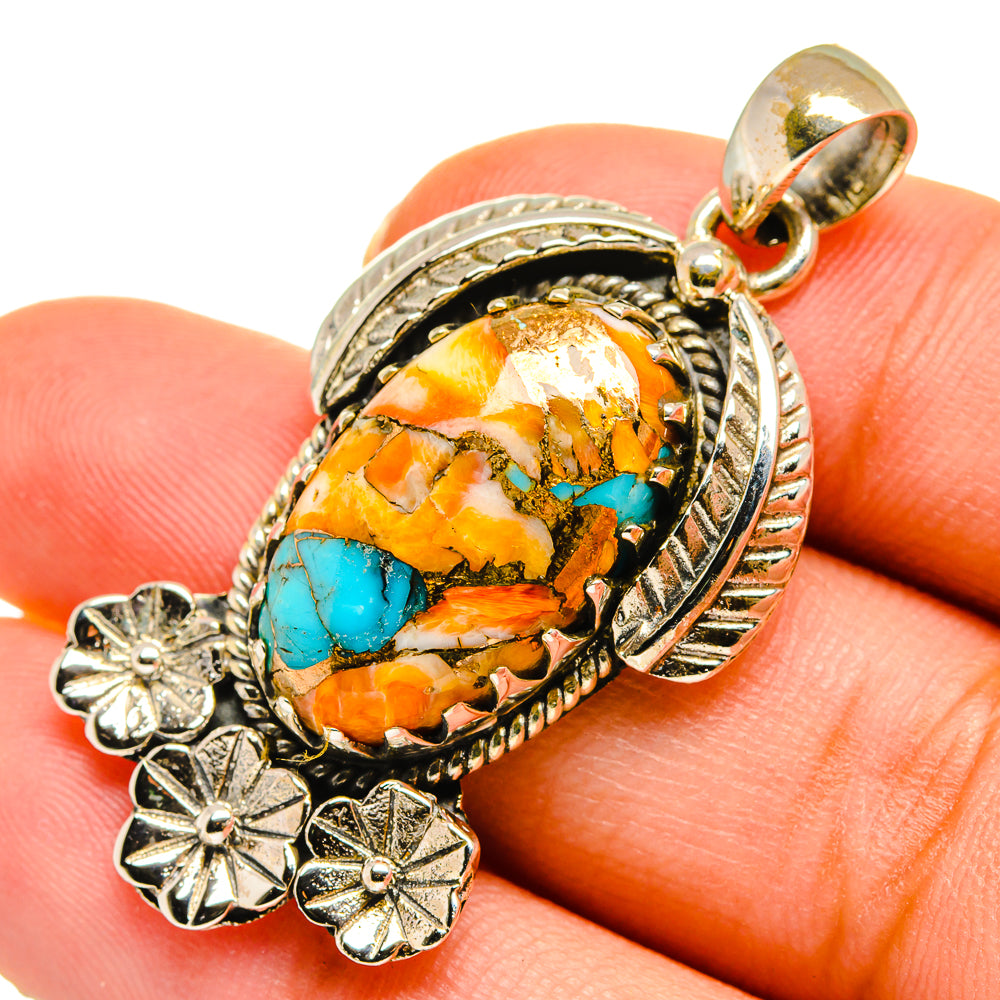 Sterling silver spiny oyster pendant close-up: turquoise-orange stone, rope bezel and floral drops