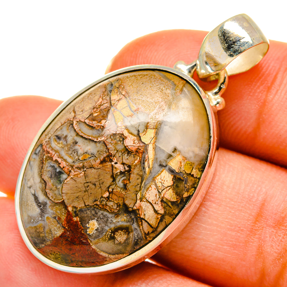 Mushroom rhyolite pendant with gold-tone bezel, oval stone cabochon, and bail loop