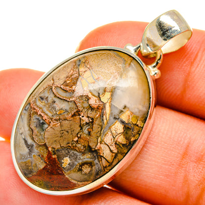 Mushroom rhyolite pendant with gold-tone bezel, oval stone cabochon, and bail loop