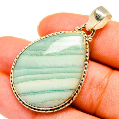Ocean jasper teardrop pendant on fingers, green striped stone in 925 sterling silver