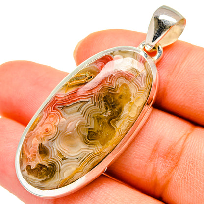 Crazy lace agate pendant in oval bezel, gold and pink banded stone with silver bail
